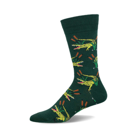 a green sock with a repeating pattern of yellow alligators with open mouths and green reeds.