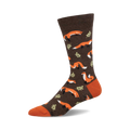 Brown crew socks with orange foxes and green leaves.  A fun, whimsical design perfect for adding a touch of personality to your outfit.