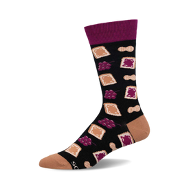 a black sock with a purple cuff. it has a pattern of peanut butter and jelly sandwiches, peanuts, and grapes.  the toe and heel are a light tan color.