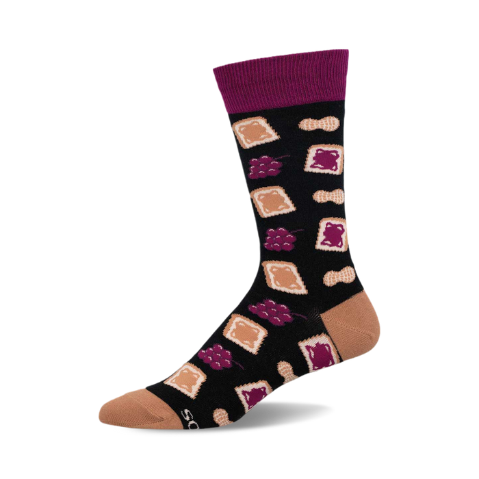 a black sock with a purple cuff. it has a pattern of peanut butter and jelly sandwiches, peanuts, and grapes.  the toe and heel are a light tan color. }}