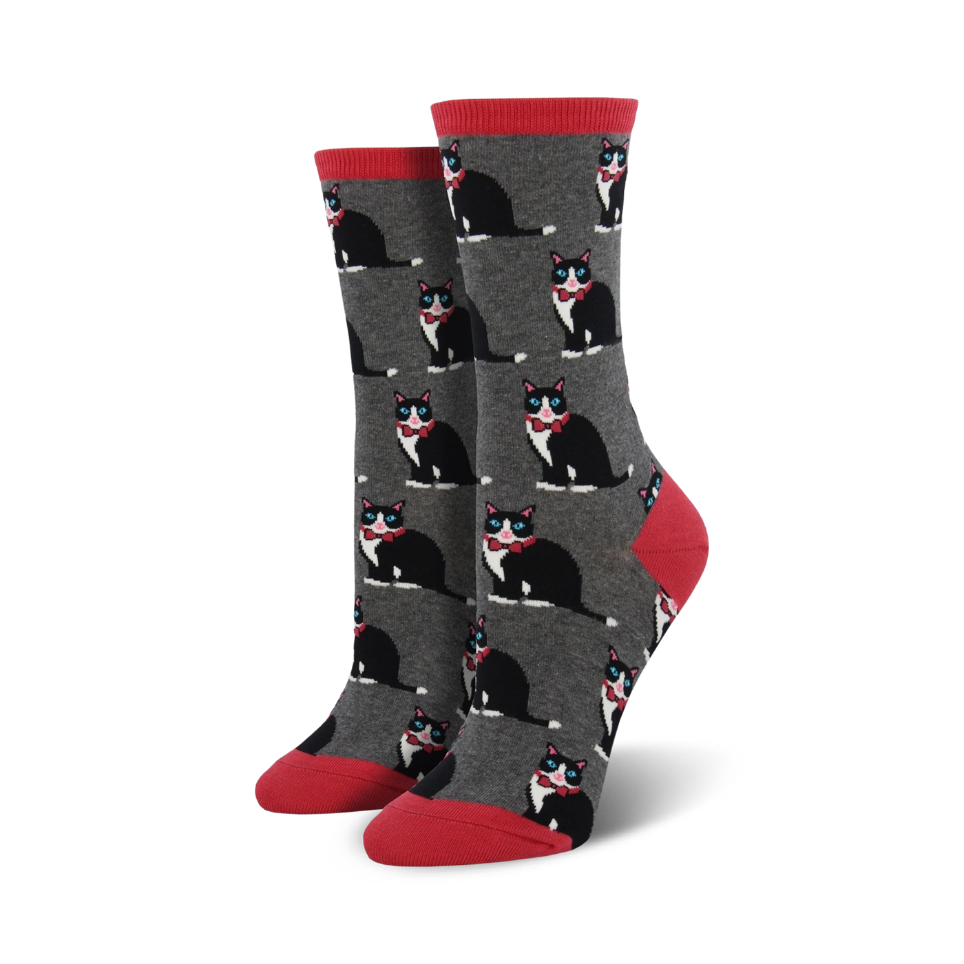 A pair of women's crew socks in gray with a repeating pattern of black tuxedo cats wearing red bow ties. The socks have coral red cuffs.