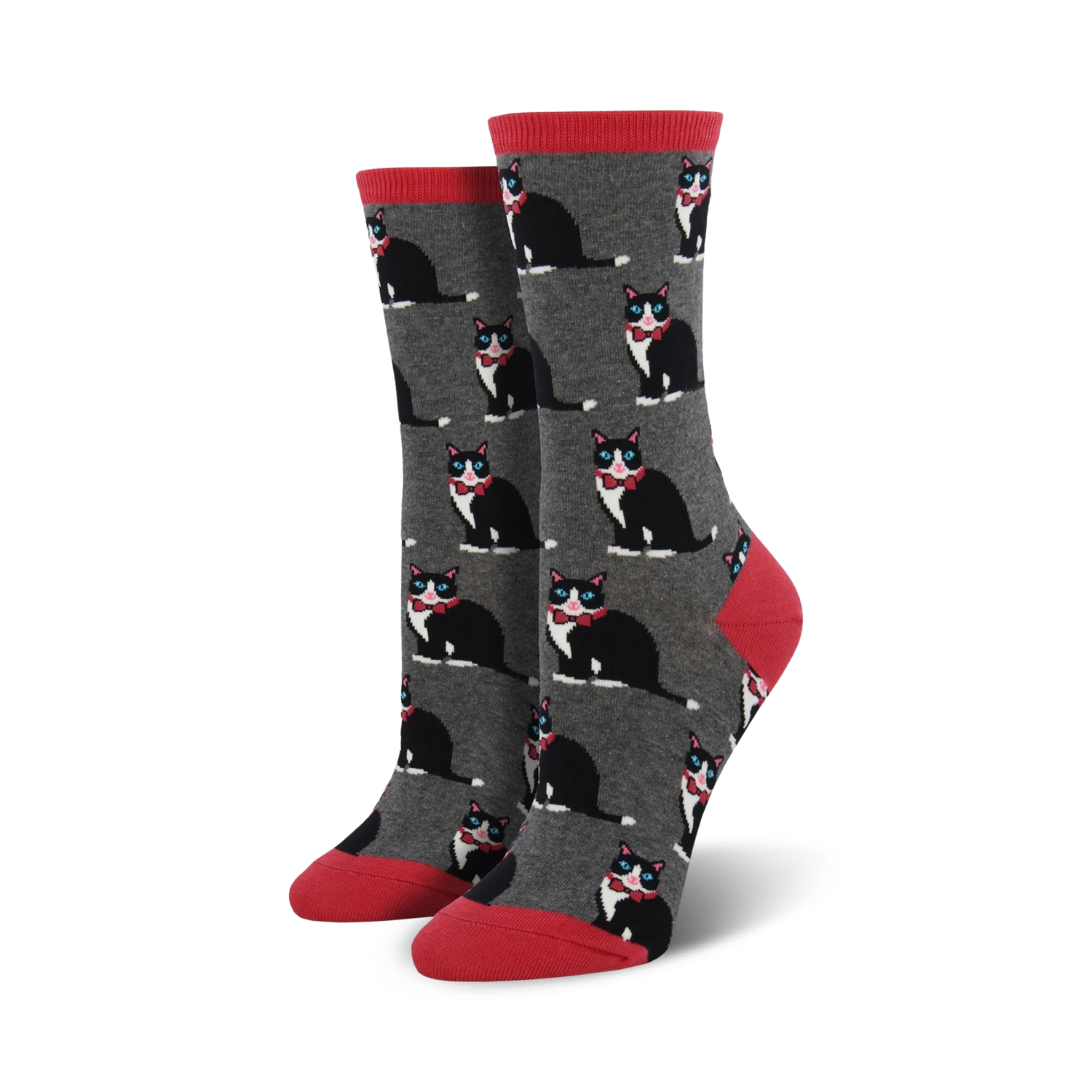 A pair of women's crew socks in gray with a repeating pattern of black tuxedo cats wearing red bow ties. The socks have coral red cuffs.