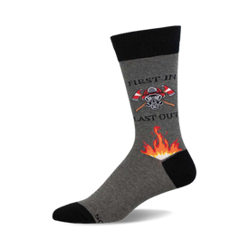 a grey sock with black trim, a fire fighter with a crossed axe graphic, and the words "first in last out". there is an orange and yellow flame graphic below the image.