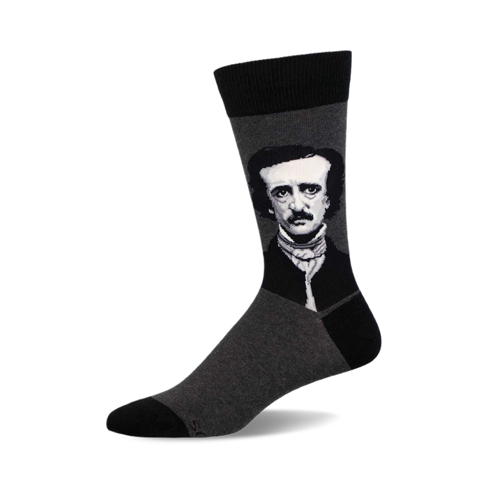 a pair of grey socks with a black and white image of edgar allan poe on the top of one sock. }}