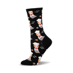 Crew socks in black with a repeating pattern of orange tabby cats wearing chef hats and baking muffins.  The words 'Purr' are also printed on the socks.