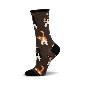 a brown sock with black and white cats and orange and white cats printed on it.  the cats are facing away from the viewer.