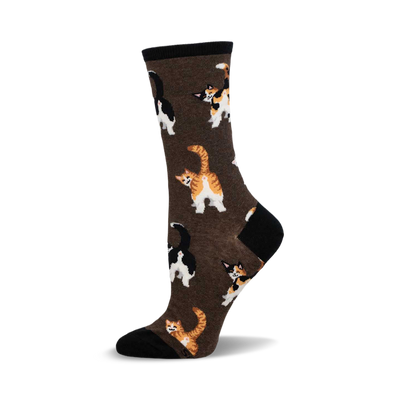 a brown sock with black and white cats and orange and white cats printed on it.  the cats are facing away from the viewer.