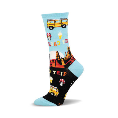 a pair of socks with a blue and black background. the socks are patterned with a yellow van, ice cream cones, mushrooms, and mountains. the words "road trip" are printed on the socks.