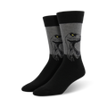 A pair of men's crew socks in black and gray. The socks feature a graphic design of a raptor's head, with yellow eyes.