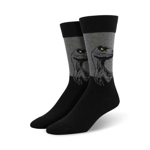 A pair of men's crew socks in black and gray. The socks feature a graphic design of a raptor's head, with yellow eyes.