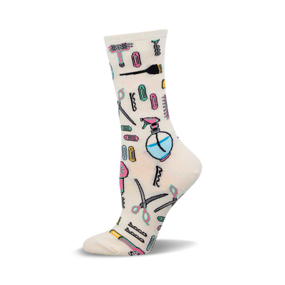 Cream crew socks with colorful illustrations of hair salon tools: scissors, hair dryers, spray bottles, combs, and brushes.