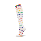 White knee-high sock with rainbow 'LOVE' text, colorful hearts, and a rainbow striped cuff. Shown on a white background.