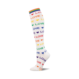 white knee-high sock with the word "love" printed on it in different colors.  each word "love" is accompanied by a small heart in the corresponding color. the sock also features a rainbow stripe at the top.