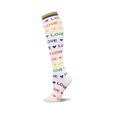 white knee-high sock with the word "love" printed on it in different colors.  each word "love" is accompanied by a small heart in the corresponding color. the sock also features a rainbow stripe at the top.