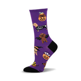 purple crew socks with a pattern of dachshunds dressed in halloween costumes.  the costumes include a witch, a skeleton, a vampire, and a pumpkin.