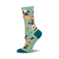 Crew socks in teal featuring pugs in pumpkin spice latte cups, orange pumpkins, and fall leaves.  Teal and orange are the main colors.