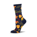 Crew socks in navy blue with yellow, orange, and red autumn leaves and the word 'Thankful' in yellow script.