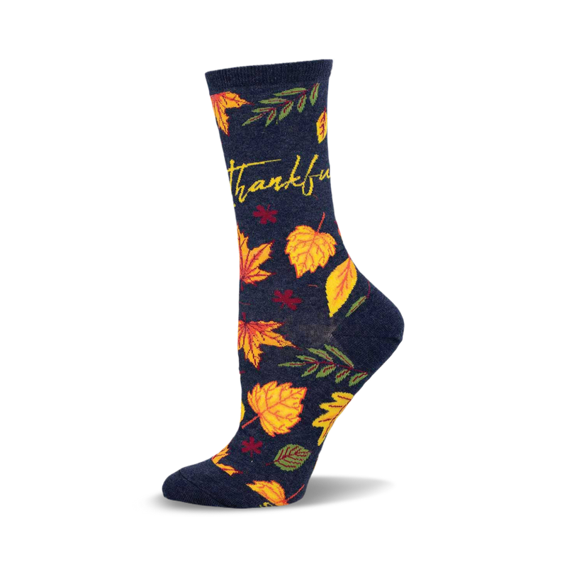 Crew socks in navy blue with yellow, orange, and red autumn leaves and the word 'Thankful' in yellow script.