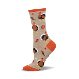 a tan sock with an orange top and a pattern of turkeys, leaves, and pumpkins.