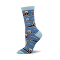 A side view of a crew sock in blue with a light blue cuff, featuring a repeating pattern of otters swimming.