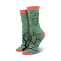 Crew socks in teal with a pink toe and heel.  Features a repeating pattern of black cherry blossom branches and pink flowers.