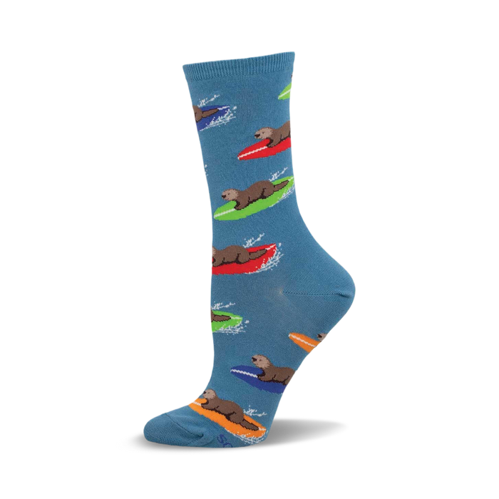 a blue sock with a pattern of otters surfing on colorful surfboards. }}