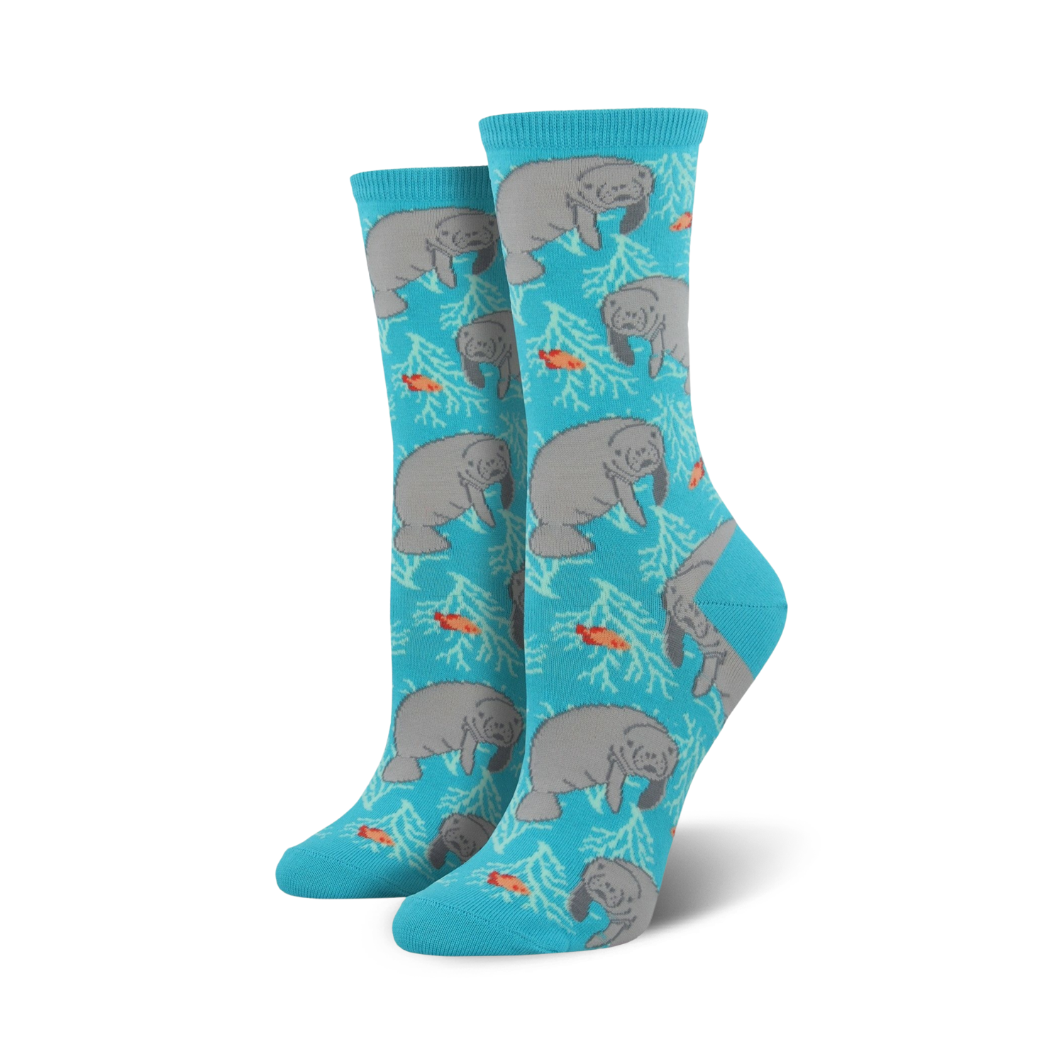 Pair of teal crew socks featuring a repeating pattern of gray manatees, orange fish, and white coral.