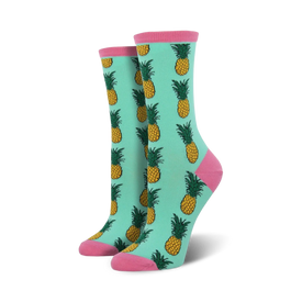 mint green socks featuring a pattern of yellow pineapples with green leaves and pink toes and heels.    