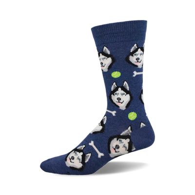 side view of navy blue socks featuring a repeating pattern of siberian husky faces, tennis balls, and bones.  "give a dog a bone" socks.