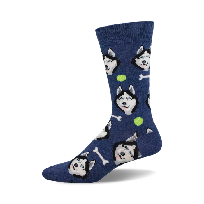 side view of navy blue socks featuring a repeating pattern of siberian husky faces, tennis balls, and bones.  