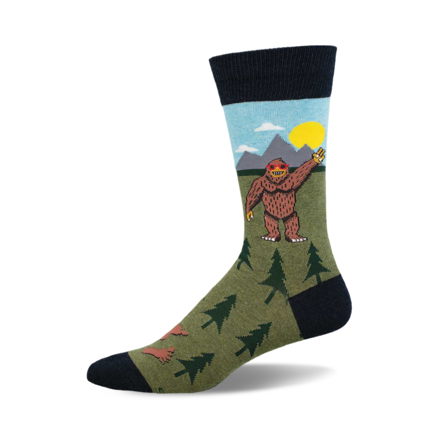 Crew socks in olive green, navy blue, and light blue, featuring a cartoon Bigfoot waving, mountains, and little trees.