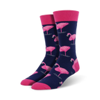 Pair of navy blue crew socks featuring a pink flamingo pattern.  Pink cuffs add a pop of color. Fun and stylish!