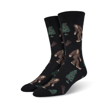 black crew socks with brown and green bigfoot and footprint pattern and pine trees. xl for men.  
