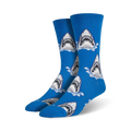 A pair of men's blue crew socks with a repeating pattern of great white shark jaws breaking the water's surface. 