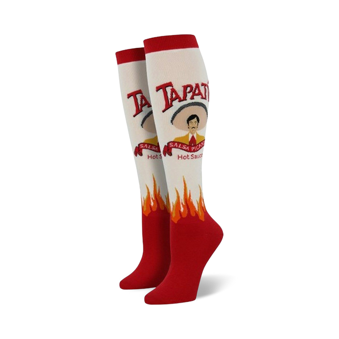  white knee-high socks for women feature red flames at the bottom and a tapatio hot sauce bottle graphic on the front with a sombrero-wearing man.  }}