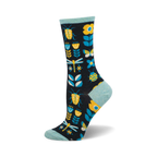 A pair of crew socks in navy blue features yellow ladybugs, dragonflies, butterflies, and flowers on a dark background. The socks have a light teal cuff.