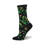 A black crew sock with a whimsical print of Venus flytraps and flies in shades of red and green. 