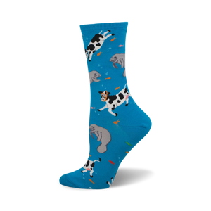 Crew socks in bright blue with a whimsical design of black and white cows and gray manatees swimming amongst orange fish.