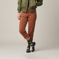 Model wearing black crew socks with white bunnies & carrots, styled with cuffed brown corduroy pants. [lf]