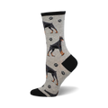 A side view of grey crew socks with a pattern of black Doberman Pinschers and grey paw prints. The socks have a black heel and toe.