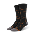 Pair of crew socks in dark grey with a repeating burnt orange caffeine molecule pattern.  The socks have grey heels and toes.
