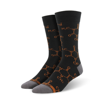 black crew socks with orange caffeine molecule pattern, ribbed top, gray toe and heel.   