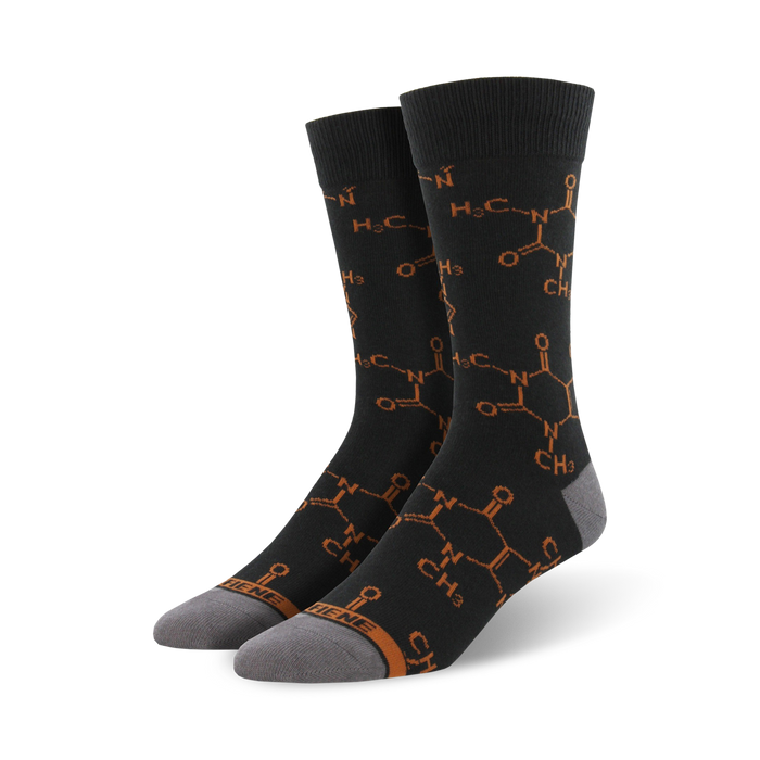 black crew socks with orange caffeine molecule pattern, ribbed top, gray toe and heel.    }}