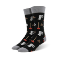 Pair of black crew socks with a fun potty-themed design.  Features illustrations of plungers, toilet paper rolls, and poop emojis.