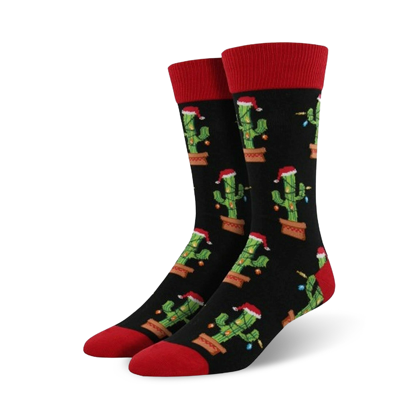 Pair of crew socks; black background with repeating pattern of cacti wearing Santa hats and Christmas lights; red cuffs.