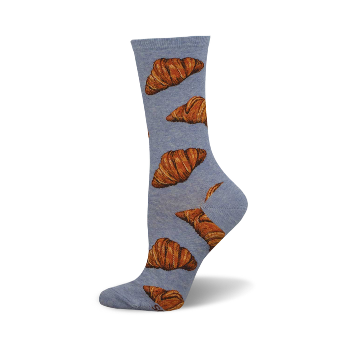 side view of flaky croissant socks; light blue socks with a pattern of brown croissants. }}