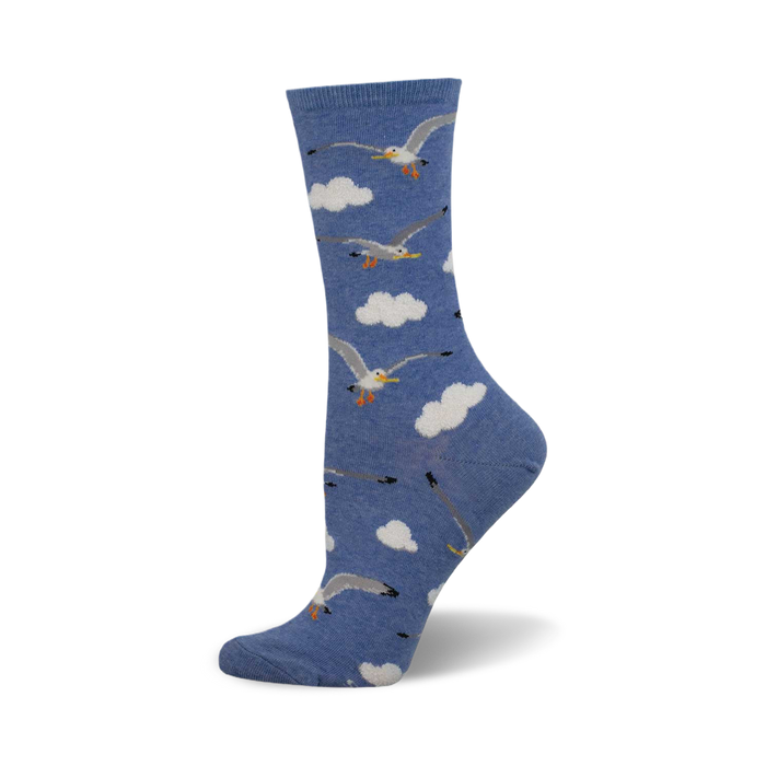 side view of 'mine now' socks; blue socks with a pattern of seagulls in flight against a cloudy sky. }}