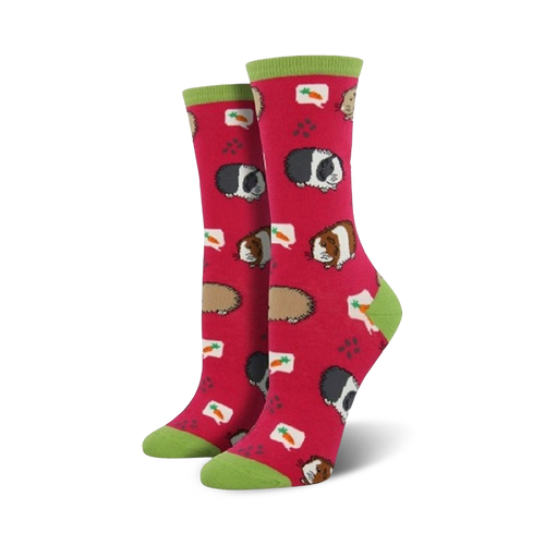 Pair of crew socks, pink and green, featuring a repeating pattern of cartoon guinea pigs and carrots.