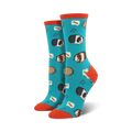 Teal crew socks with guinea pig design shown on a person's feet, next to a succulent plant.