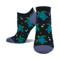 A pair of navy blue ankle socks adorned with a playful pattern of teal and green sea turtles and white dots.